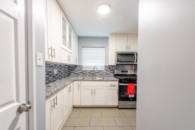 kitchen featuring white cabinetry, appliances with stainless steel finishes, and light stone counters