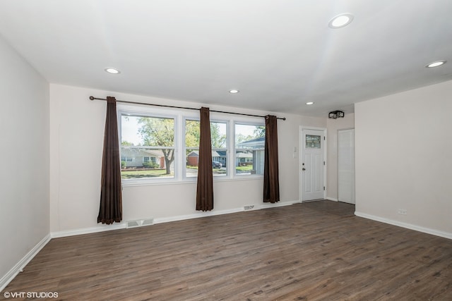 spare room with dark wood-type flooring