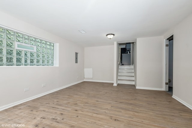 unfurnished room featuring light wood-type flooring and electric panel