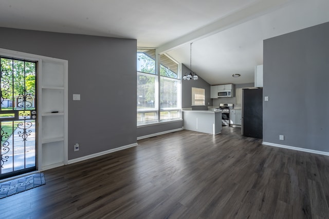 unfurnished living room with an inviting chandelier, vaulted ceiling with beams, and dark hardwood / wood-style floors