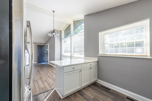 kitchen with stainless steel refrigerator, lofted ceiling with beams, dark hardwood / wood-style floors, and white cabinetry