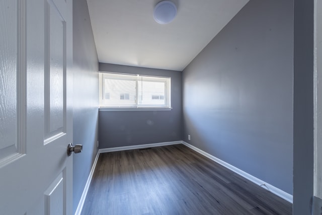 unfurnished room featuring dark hardwood / wood-style flooring