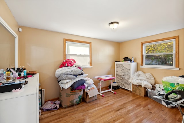 bedroom featuring multiple windows and light hardwood / wood-style floors