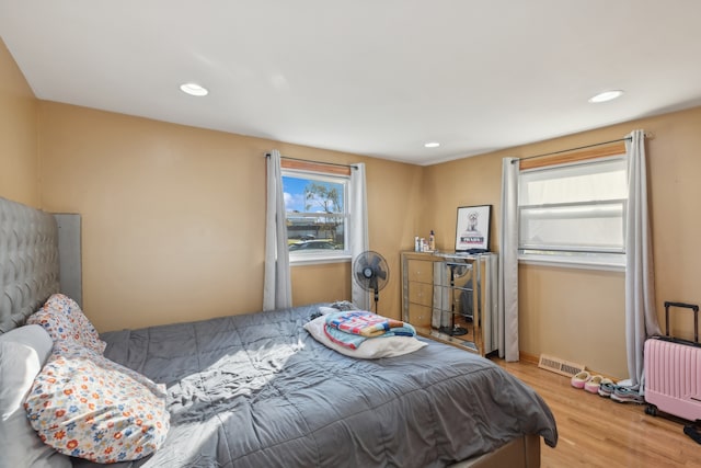 bedroom with radiator and light wood-type flooring