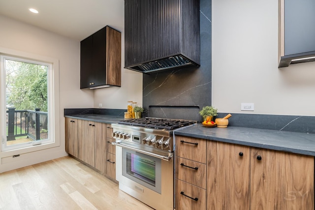 2715 Reese Ave, Evanston, IL 60201 - kitchen with high end stove, wall chimney exhaust hood, dark countertops, light wood-style floors, and decorative backsplash