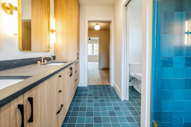 2715 Reese Ave, Evanston, IL 60201 - full bathroom with tile patterned floors, toilet, double vanity, baseboards, and a shower