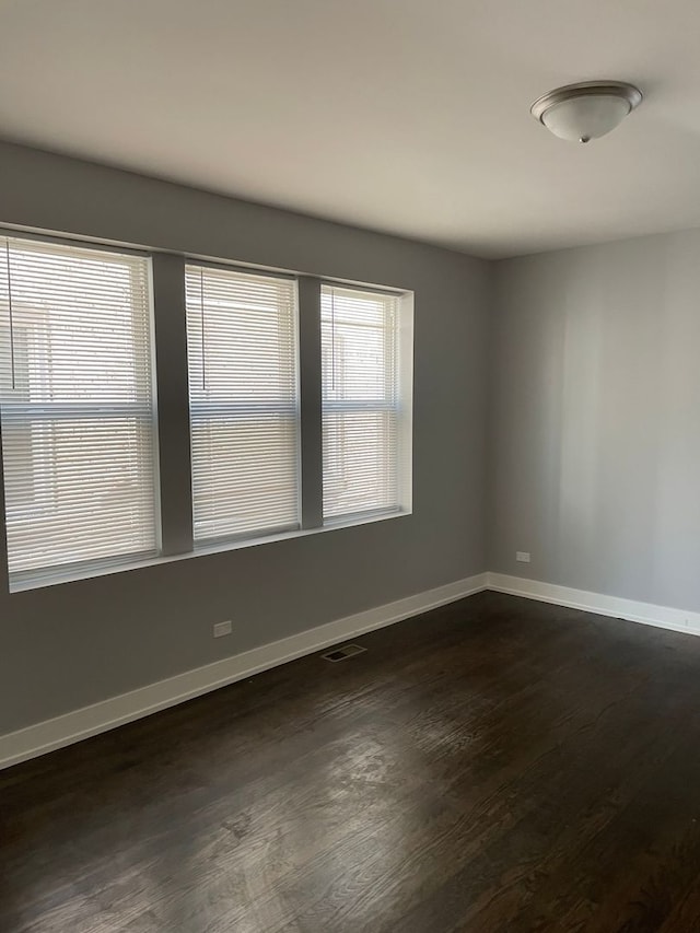 empty room with dark wood-type flooring