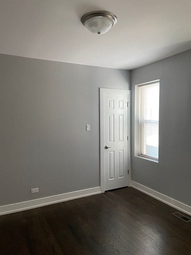 unfurnished room with dark hardwood / wood-style floors