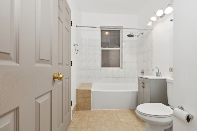 full bathroom with tiled shower / bath, vanity, toilet, and tile patterned floors