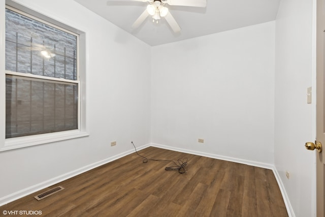 spare room with ceiling fan and dark hardwood / wood-style flooring