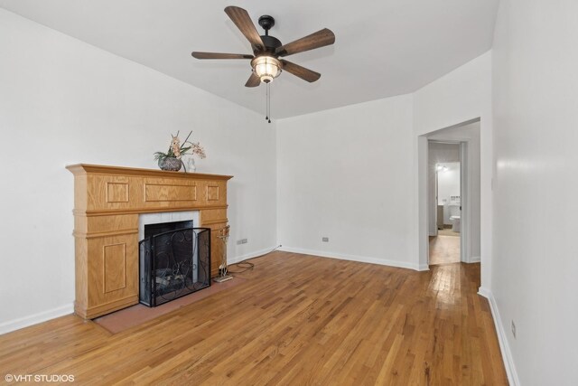 6049 S Eberhart Ave Unit 1-N, Chicago, IL 60637 - unfurnished living room featuring ceiling fan, a fireplace, light wood finished floors, and baseboards