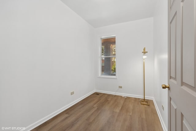 empty room with hardwood / wood-style flooring