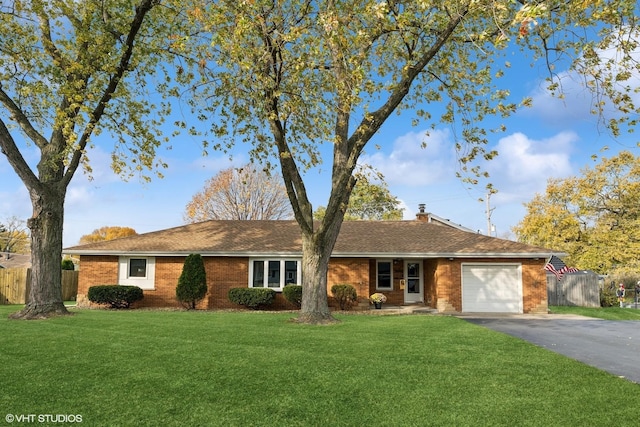 single story home with aphalt driveway, a garage, fence, and a front lawn