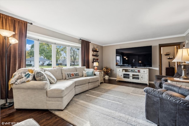 living room featuring baseboards, ornamental molding, and wood finished floors