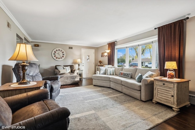 living area with visible vents, ornamental molding, and wood finished floors