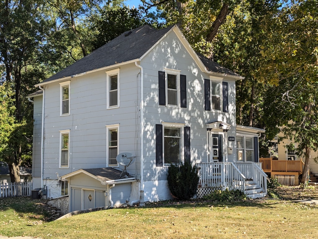 view of front of home featuring a front yard and a deck