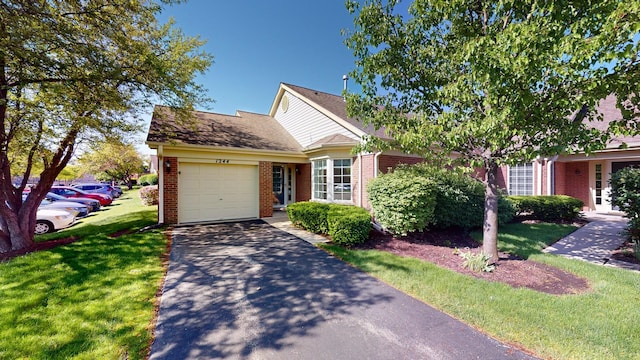 view of front of house with a front yard and a garage