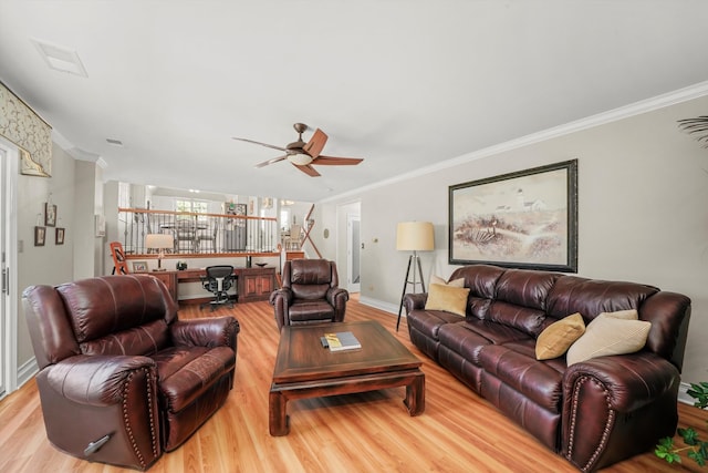 living room featuring ceiling fan, ornamental molding, and light hardwood / wood-style flooring