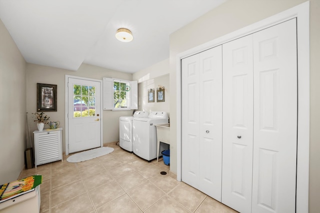 washroom with washer and clothes dryer and light tile patterned floors