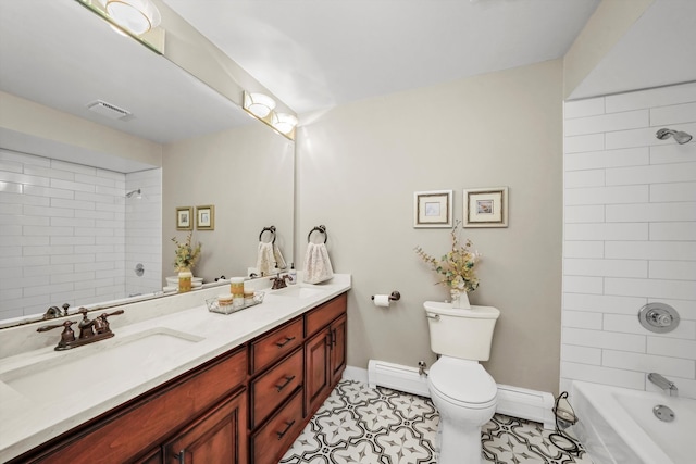 full bathroom featuring tile patterned floors, toilet, baseboard heating, tiled shower / bath, and vanity