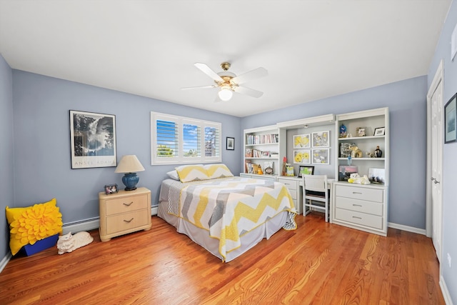 bedroom featuring a baseboard heating unit, light hardwood / wood-style floors, and ceiling fan