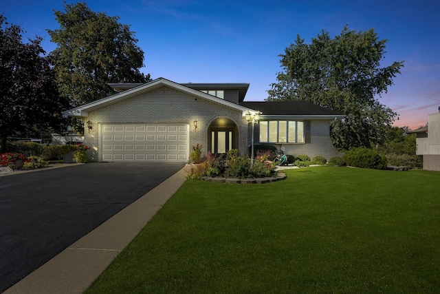 view of front of home featuring a yard and a garage