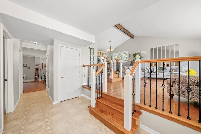 staircase featuring vaulted ceiling with beams, a chandelier, and tile patterned flooring