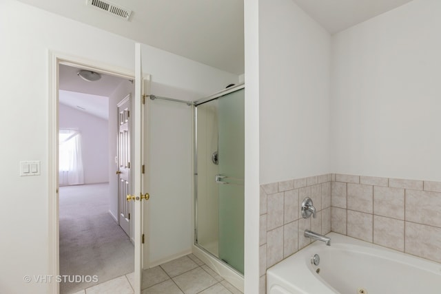 bathroom with tile patterned flooring and separate shower and tub