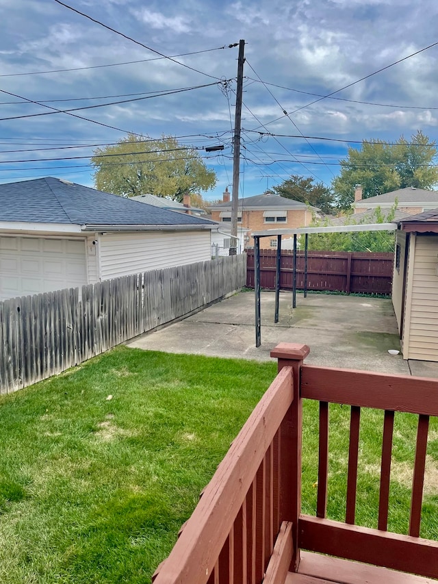 view of yard featuring a patio area, a garage, and an outdoor structure