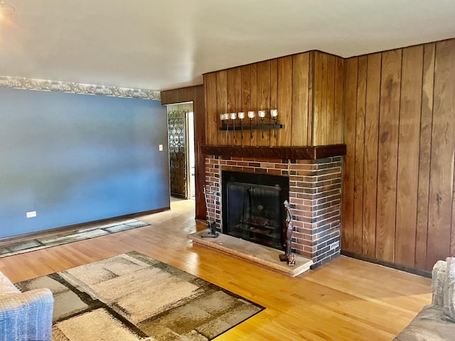 679 Manistee Ave, Calumet City, IL 60409 - living area featuring baseboards, wood walls, wood finished floors, and a fireplace