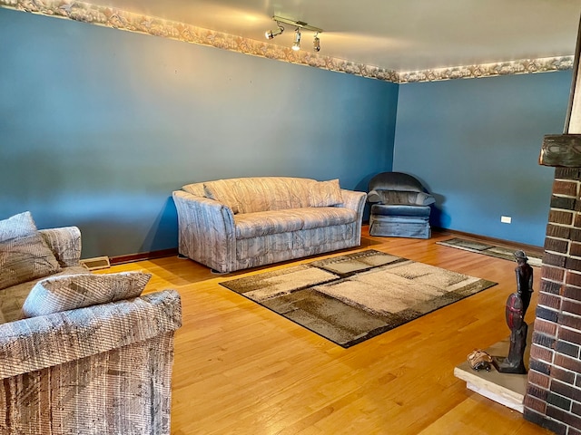 interior space with hardwood / wood-style floors and a brick fireplace