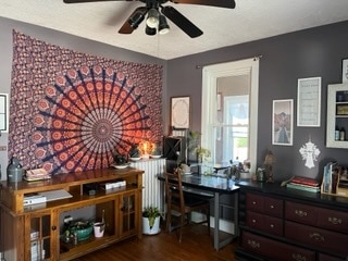 office space with hardwood / wood-style floors, ceiling fan, and radiator