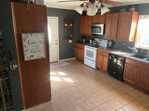 kitchen featuring sink, dishwasher, backsplash, ceiling fan, and white electric range