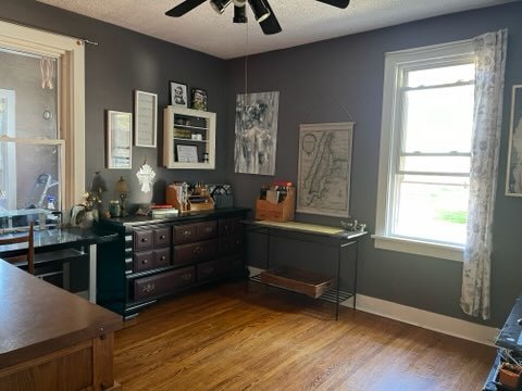 interior space featuring a textured ceiling, wood-type flooring, and ceiling fan