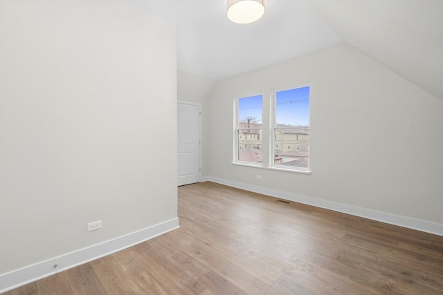 bonus room with wood-type flooring and lofted ceiling