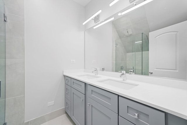 bathroom featuring vanity, a shower with door, and tile patterned floors