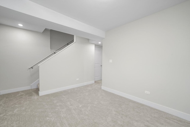 basement featuring light carpet