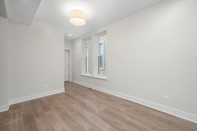 spare room featuring light hardwood / wood-style flooring