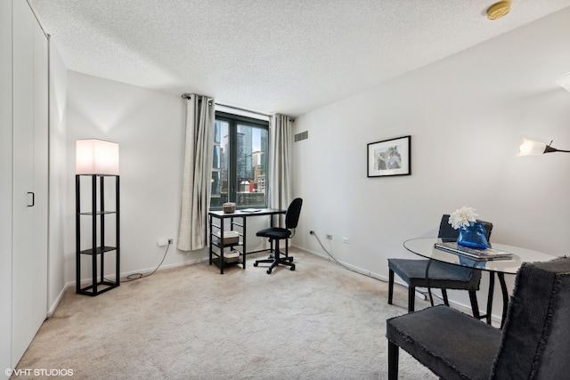 carpeted home office with a textured ceiling