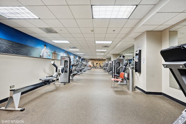 workout area featuring a paneled ceiling and carpet