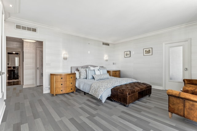 bedroom featuring hardwood / wood-style flooring and ornamental molding