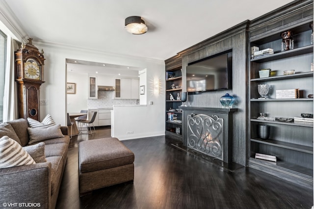 living room with a fireplace, dark hardwood / wood-style floors, and crown molding