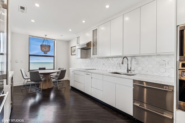 kitchen featuring white cabinets, a wealth of natural light, sink, and dark hardwood / wood-style floors