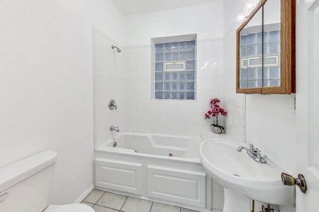 full bathroom featuring toilet, sink, tile patterned flooring, and tiled shower / bath