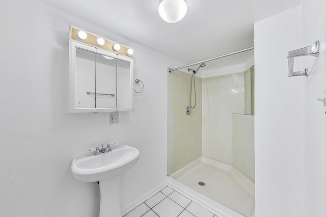 bathroom with walk in shower and tile patterned floors