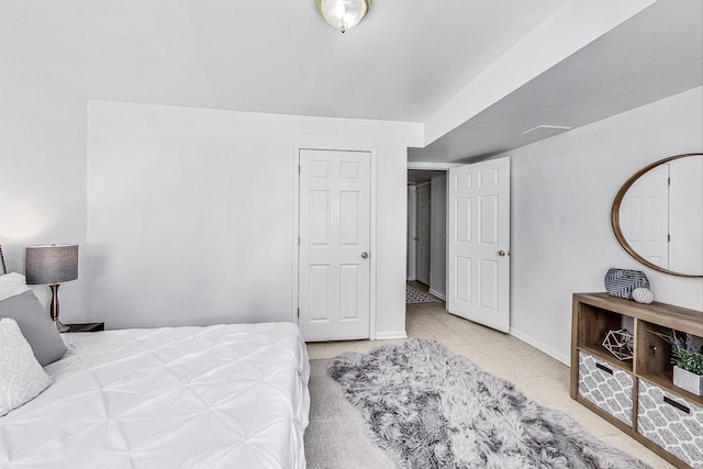 bedroom featuring light tile patterned floors