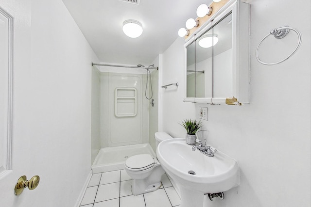 bathroom featuring sink, tile patterned flooring, toilet, and walk in shower