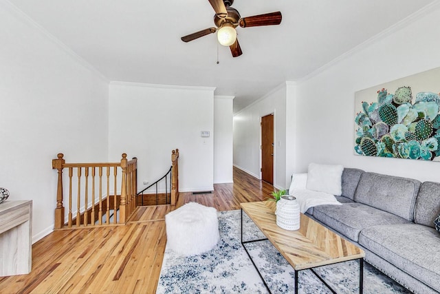 living room with crown molding, wood-type flooring, and ceiling fan