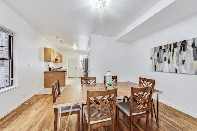 dining space with light hardwood / wood-style flooring