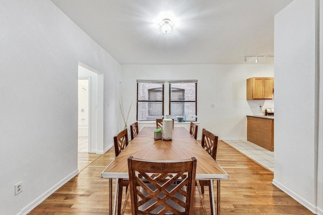 dining area with light hardwood / wood-style floors